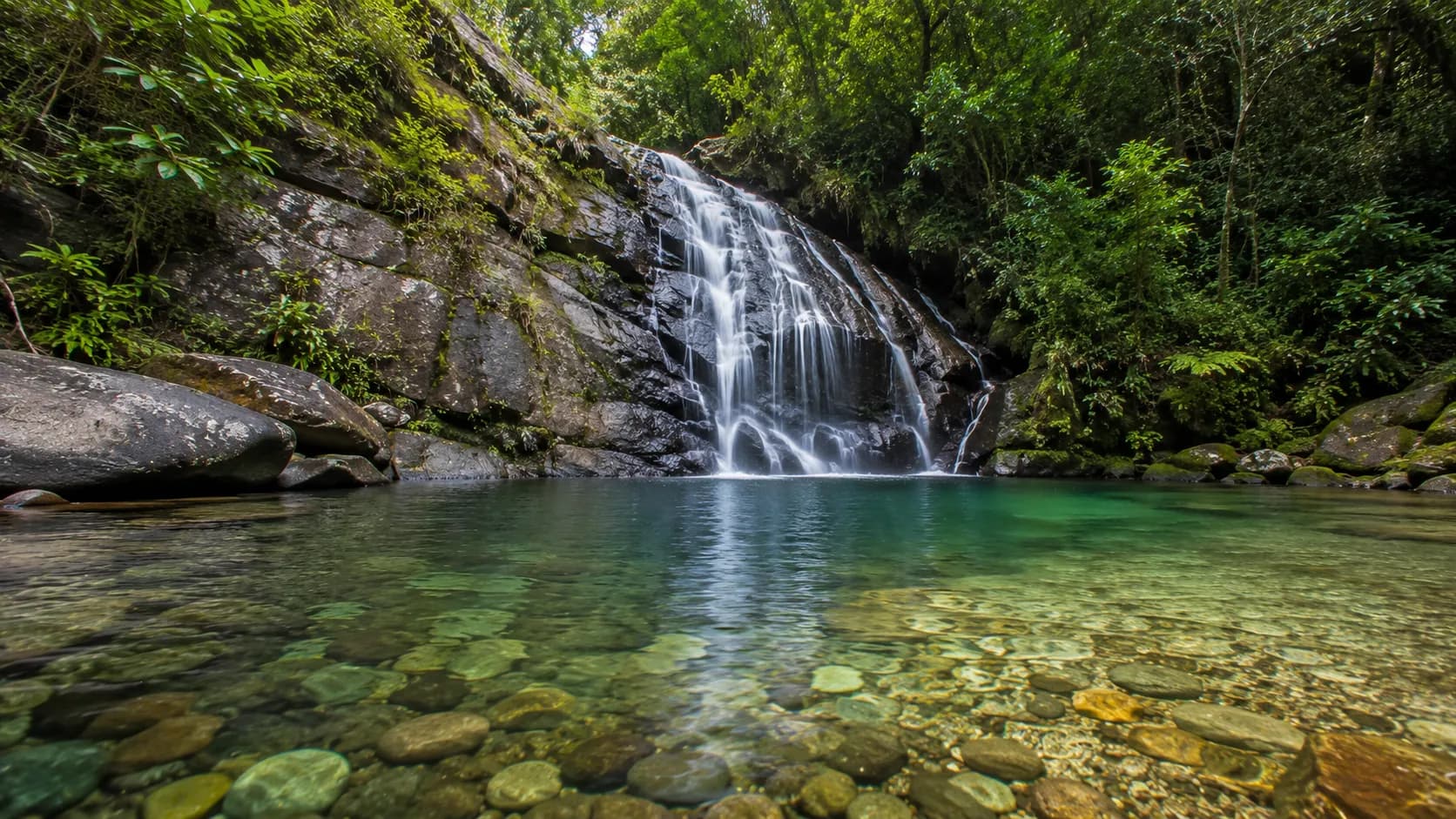 Crystal clear natural pool at Lakkam Waterfalls Munnar